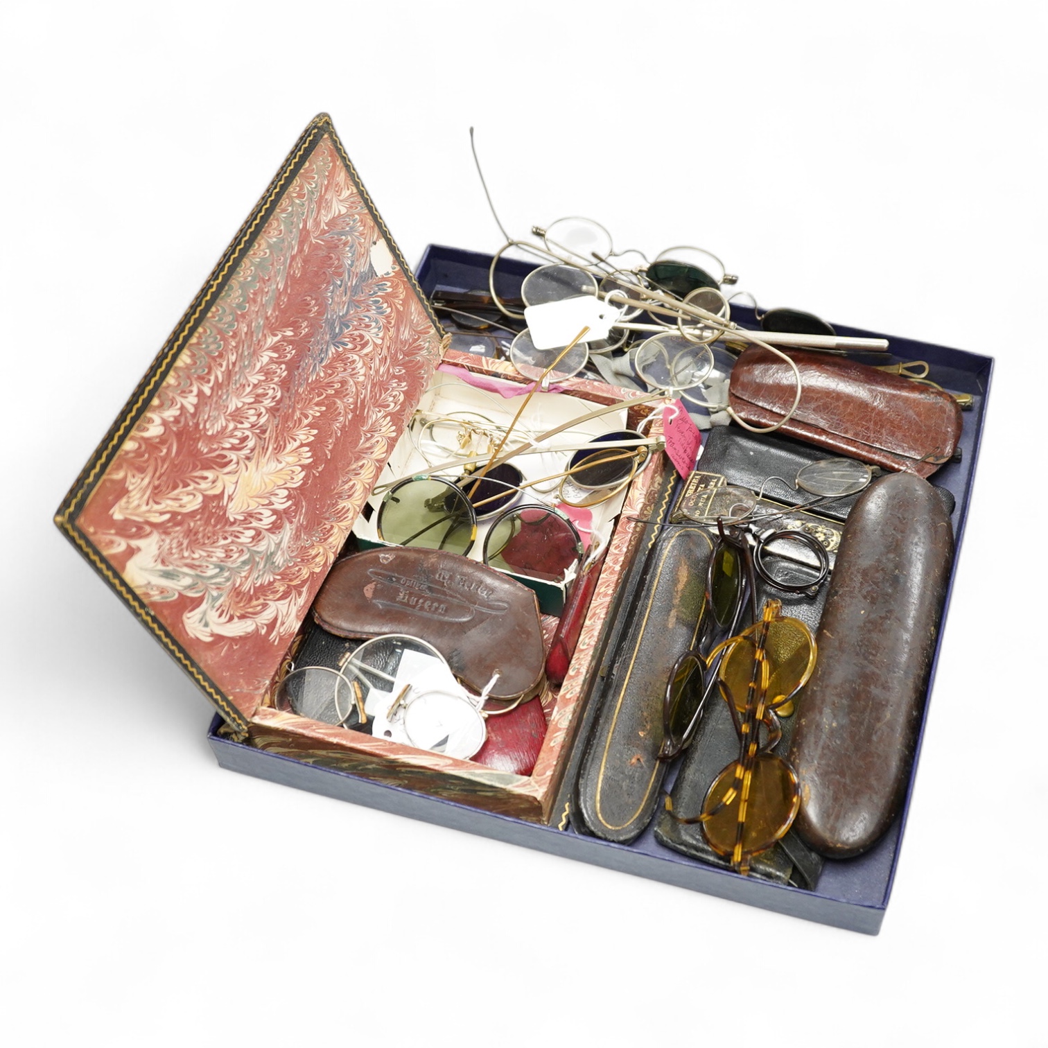 A collection of 18th-20th century steel, nickel, tortoiseshell, brass or faux tortoiseshell spectacles, some cased, five 19th century pince nez, some cased and a quizzing glass etc.